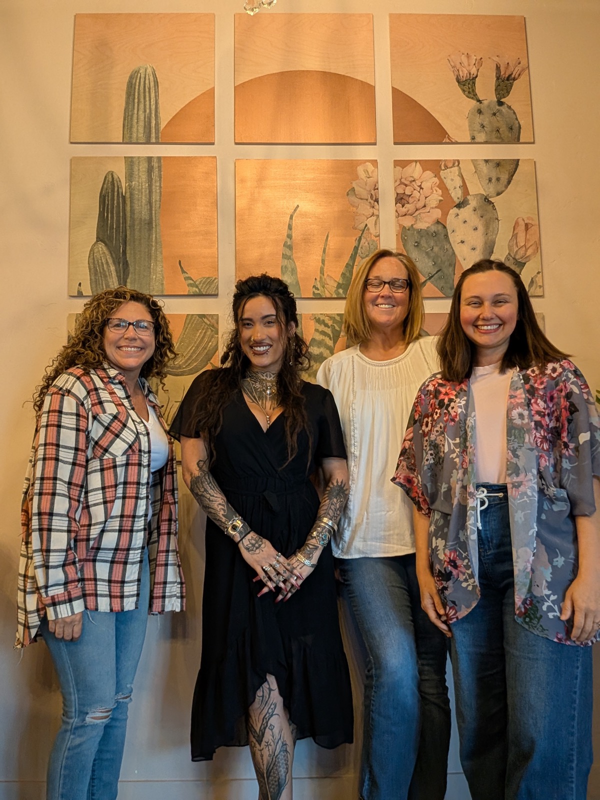 A group of four women smiling together at a Studio Willow workshop